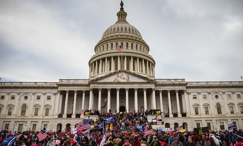 WASHINGTON, DC - JANUARY 06: A large group of pro-Trump protesters stand on the East steps of the Capitol Building after storming its grounds on January 6, 2021 in Washington, DC. A pro-Trump mob stormed the Capitol, breaking windows and clashing with police officers. Trump supporters gathered in the nation's capital today to protest the ratification of President-elect Joe Biden's Electoral College victory over President Trump in the 2020 election. (Photo by Jon Cherry/Getty Images)