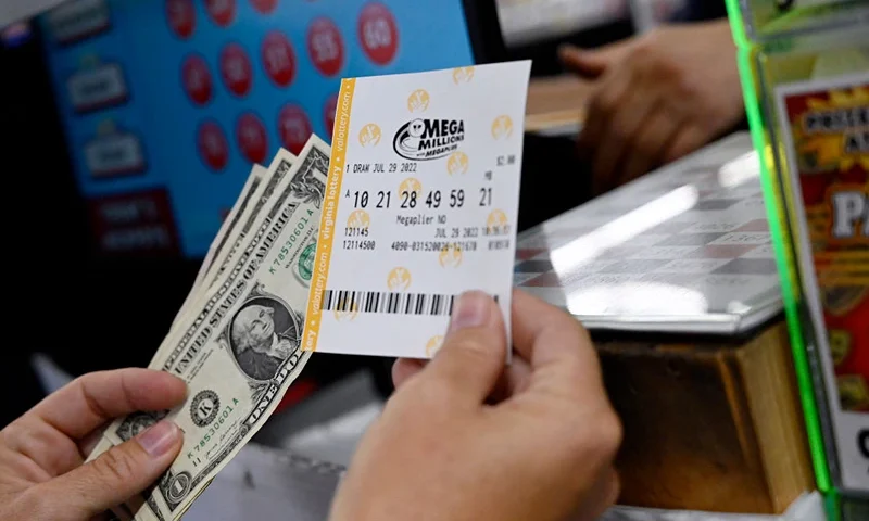 A person buys a Mega Millions lottery ticket at a store on July 29, 2022 in Arlington, Virginia. The jackpot for Friday's Mega Millions is now $1.1 billion, the second-largest jackpot in game history. (Photo by OLIVIER DOULIERY / AFP) (Photo by OLIVIER DOULIERY/AFP via Getty Images)
