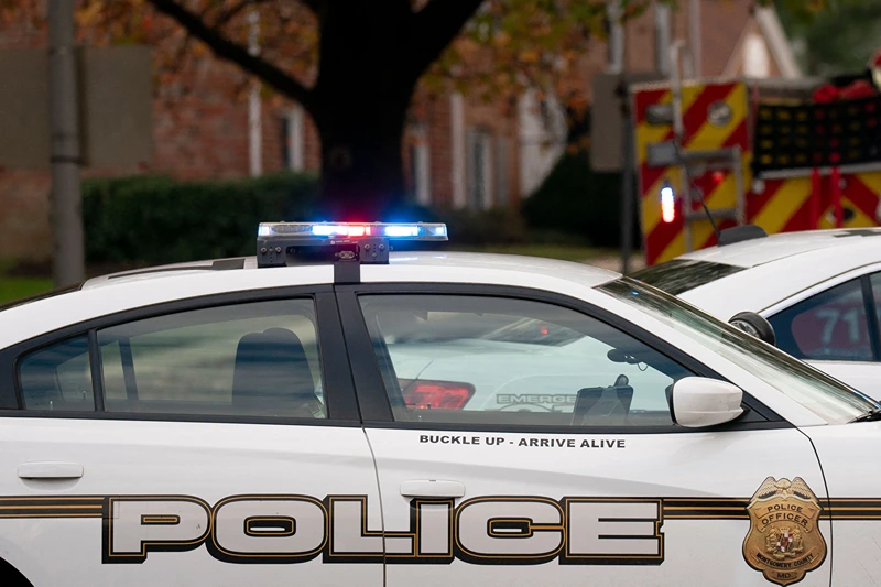 Police vehicles block the street near the site of a fire caused by an explosion at an apartment building in which 12 people were reported injured, according to officials, in Gaithersburg, Maryland on November 16, 2022. - A preliminary report by fire department officials indicate the explosion was a gas leak. (Photo by Stefani Reynolds / AFP) (Photo by STEFANI REYNOLDS/AFP via Getty Images)