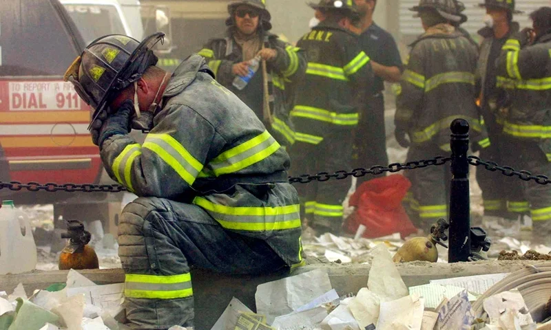 NEW YORK - SEPTEMBER 11: Firefighter Gerard McGibbon, of Engine 283 in Brownsville, Brooklyn, prays after the World Trade Center buildings collapsed September 11, 2001 after two hijacked airplanes slammed into the twin towers in a terrorist attack that killed some 3,000 people. (Photo by Mario Tama/Getty Images)