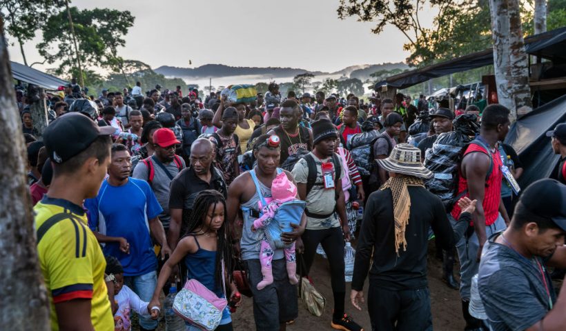 LAS TEKAS, COLOMBIA - OCTOBER 07: Migrants, most from Haiti, depart a base camp towards the jungle in the infamous Darien Gap while on their journey towards the United States on October 07, 2021 at Las Tekas, Colombia. The passage, which can take up to a week, is considered the most dangerous stretch for migrants traveling from South America to the U.S. During the trip, torrential downpours lead to sudden river floodings, often resulting in migrant drownings along the way. More than 70,000 migrants have traveled through the Darien Gap this year, according to Panamanian authorities. Most of the migrants in recent months have been Haitians, many of whom had been living in Chile and Brazil since the 2010 Haitian earthquake. The Darien Gap is the 66-mile stretch of rainforest between North and South America where the Panamerican Highway was never completed due to severe terrain, enormous cost and myriad environmental concerns. (Photo by John Moore/Getty Images)