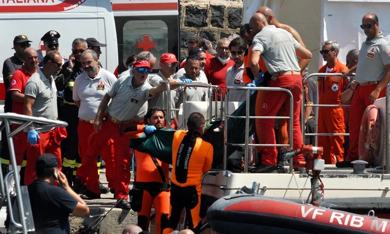 Divers of the Vigili del Fuoco, the Italian Corps. of Firefighters carry the body of Hannah Lynch, the last missing person at Porticello harbor near Palermo, on August 23, 2024, four days after the British-flagged luxury yacht Bayesian sank. Divers searching a sunken superyacht off Sicily for UK tech tycoon Mike Lynch's teenage daughter found a body, a coastguard official told AFP. Lynch's daughter Hannah, 18, had been the last person missing after his family's luxury yacht sank off the Italian island killing the businessman and five others. The Bayesian, which had 22 people aboard including 10 crew, was anchored some 700 metres from port before dawn when it was struck by a waterspout. (Photo by Alessandro FUCARINI / AFP) (Photo by ALESSANDRO FUCARINI/AFP via Getty Images)