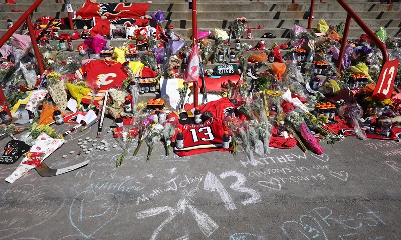 Flowers signs, and other memorabilia are laid at a memorial on the steps at the Scotiabank Saddledome as hockey fans pay their respects to former Calgary Flames star Johnny Gaudreau and his brother Matthew on August 31, 2024, in Calgary, Alberta, Canada. The brothers were killed on August 29 by a suspected drunk driver while they were cycling in Salem County, New Jersey. (Photo by Leah Hennel/Getty Images)
