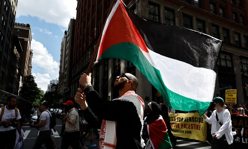 TOPSHOT - Demonstrators wave Palestinian flags and hold banners as they rally through the streets against the conflict in Gaza and the occupied West Bank on September 2, 2024 in New York City, amid the ongoing conflict between Israel and the Palestinian Hamas movement. (Photo by John Lamparski / AFP) (Photo by JOHN LAMPARSKI/AFP via Getty Images)