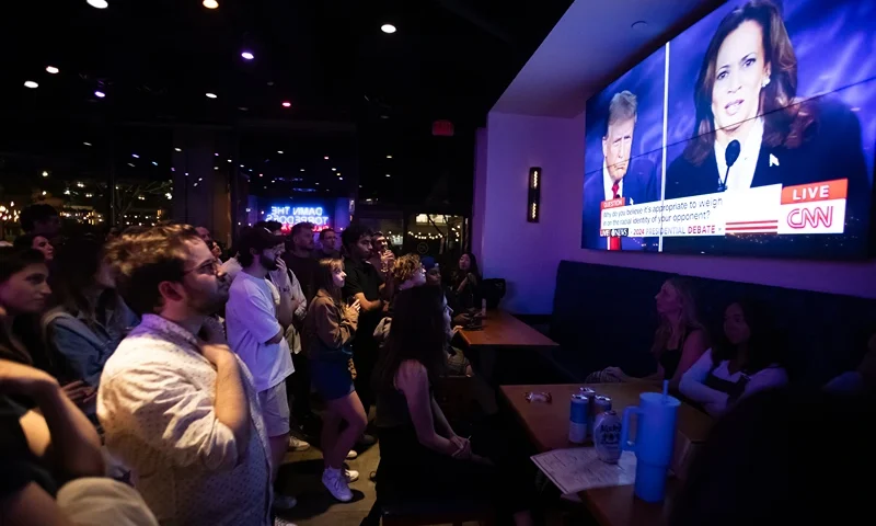People attend a watch party for the US Presidential debate between Vice President and Democratic presidential candidate Kamala Harris and former US President and Republican presidential candidate Donald Trump at The Admiral in Washington, DC, on September 10, 2024. (Photo by Allison Bailey / AFP) (Photo by ALLISON BAILEY/AFP via Getty Images)