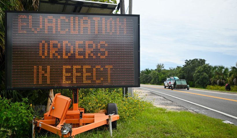 A sign displays evacuation orders as preparations are made for the arrival of Hurricane Helene, in Cedar Key, Florida on September 25, 2024. Thousands of residents on Wednesday began evacuating parts of coastal Florida as the US state braces for Hurricane Helene, forecast to barrel ashore as a powerful, potentially deadly storm. Helene strengthened into a hurricane mid-morning in the Gulf of Mexico and is "expected to bring life-threatening storm surge, damaging winds, and flooding rains to a large portion of Florida and the Southeastern United States," the National Hurricane Center in Miami said in its latest bulletin. (Photo by Miguel J. Rodriguez Carrillo / AFP) (Photo by MIGUEL J. RODRIGUEZ CARRILLO/AFP via Getty Images)
