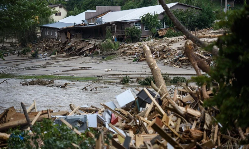 The Rocky Broad River flows into Lake Lure and overflows the town with debris from Chimney Rock, North Carolina after heavy rains from Hurricane Helene on September 28, 2024, in Lake Lure, North Carolina. Approximately six feet of debris piled on the bridge from Lake Lure to Chimney Rock, blocking access. (Photo by Melissa Sue Gerrits/Getty Images)