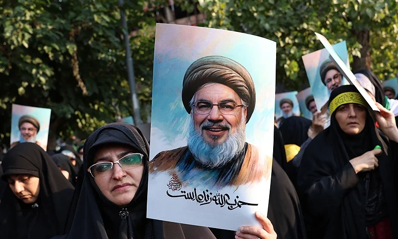 Iranian women hold pictures of Hezbollah leader Hassan Nasrallah, who was killed in an Israeli air strike on Beirut's southern suburbs on September 27, during an anti-Israel protest in Palestine Square in Tehran on September 30, 2024. (Photo by ATTA KENARE / AFP) (Photo by ATTA KENARE/AFP via Getty Images)