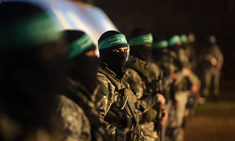 TOPSHOT - Palestinian members of the Ezzedine al-Qassam Brigades, the armed wing of the Hamas movement, take part in a gathering on January 31, 2016 in Gaza city to pay tribute to their fellow militants who died after a tunnel collapsed in the Gaza Strip. Seven Hamas militants were killed on January 28, 2016 after a tunnel built for fighting Israel collapsed in the Gaza Strip, highlighting concerns that yet another conflict could eventually erupt in the Palestinian enclave. (Photo by MAHMUD HAMS / AFP) (Photo by MAHMUD HAMS/AFP via Getty Images)