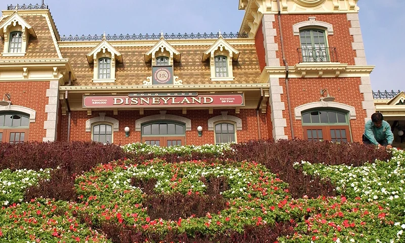 In this Handout photo provided by Disney, horticultural cast members Tina Tan (L) and Ojon Siu plant flowers in the shape of Mickey Mouse at the entrance to Hong Kong Disneyland Park August 26, 2005 in Hong Kong, China. Hong Kong Disneyland Resort, consisting of a Disneyland theme park and two Disney resort hotels, will officially open September 12, 2005. (Photo by Matt Stroshane/Disney via Getty Images)