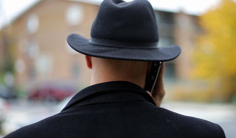 Washington, UNITED STATES: District of Columbia Council Member and soon to be Mayor Elect Adrian Fenty makes a cell phone call while wearing his trademark fedora hat while visiting polling precincts 07 November, 2006 at Nalle Elementary School in South East Washington, DC. The Disctrict of Columbia has no representation in the US Congress but under a "home rule" law passed in the 1970's, has had an elected Mayor and Council. AFP PHOTO/Tim SLOAN (Photo credit should read TIM SLOAN/AFP via Getty Images)