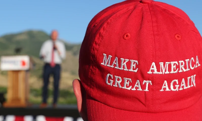 OREM, UT - JUNE 26: A Romney supporter listens to a speaker as he wears a "Make America Great Again" hat at the Mitt Romney election party on June 26, 2018 in Orem, Utah. It is primary election day in Utah and Romney is running for the Utah U.S. Senate seat of Senator Orin Hatch who is retiring. (Photo by George Frey/Getty Images)