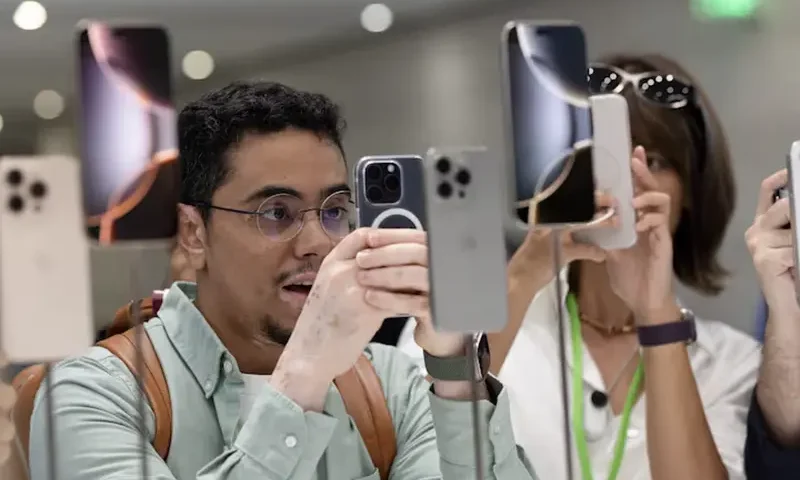An attendee takes a photo of the new iPhone 16 as Apple holds an event at the Steve Jobs Theater on its campus in Cupertino, California, U.S. September 9, 2024. REUTERS/Manuel Orbegozo/File Photo