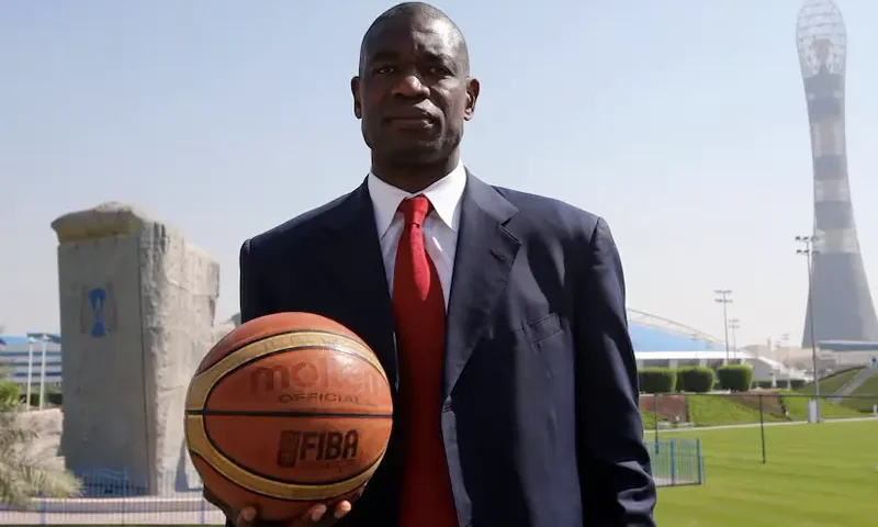 Former NBA star Dikembe Mutombo of U.S. poses before the start of a news conference at the Sports Congress and Exhibition at Aspire Dome in Doha November 12, 2012. REUTERS/Fadi Al-Assaad/File Photo