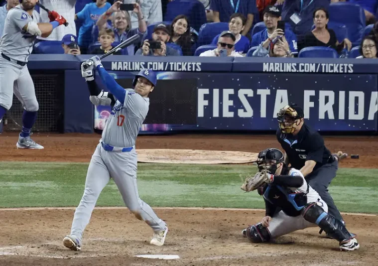 Los Angeles Dodgers designated hitter Shohei Ohtani (17) hits his 50th home run of the season against the Miami Marlins during the seventh inning at loanDepot Park. Mandatory Credit: Rhona Wise-Imagn Images