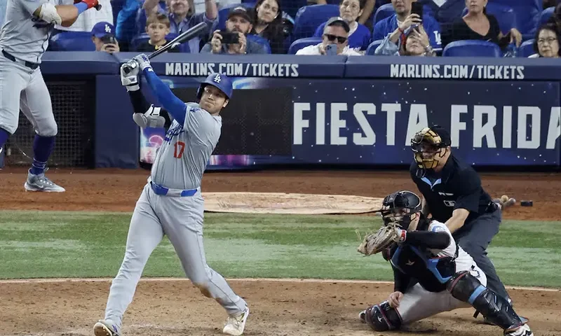 Los Angeles Dodgers designated hitter Shohei Ohtani (17) hits his 50th home run of the season against the Miami Marlins during the seventh inning at loanDepot Park. Mandatory Credit: Rhona Wise-Imagn Images