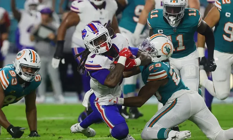 Buffalo Bills running back James Cook (4) runs with the football against Miami Dolphins cornerback Kendall Fuller (29) during the first quarter at Hard Rock Stadium. Mandatory Credit: Sam Navarro-Imagn Images