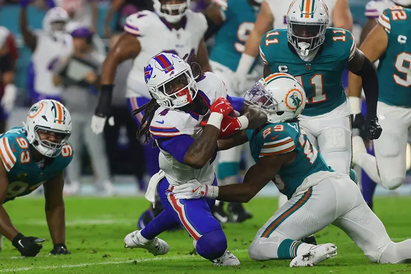 Buffalo Bills running back James Cook (4) runs with the football against Miami Dolphins cornerback Kendall Fuller (29) during the first quarter at Hard Rock Stadium. Mandatory Credit: Sam Navarro-Imagn Images