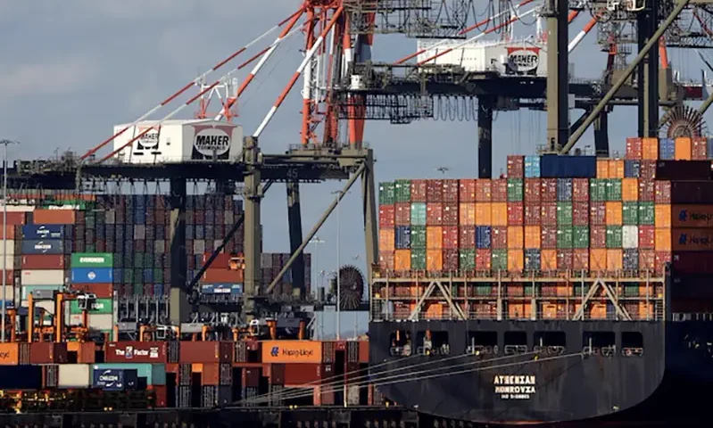 A ship stacked with shipping containers is unloaded on a pier at Port Newark, New Jersey, U.S., November 19, 2021. REUTERS/Mike Segar/File Photo
