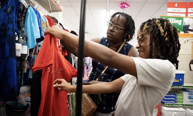 Tonya Young and her grandson Anthony Young shop at a Family Dollar store in Nashville, August 17, 2024. REUTERS/Kevin Wurm