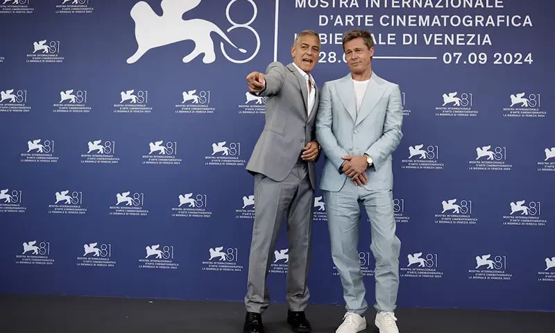 Cast members Brad Pitt and George Clooney pose during a photocall for the movie "The Wolfs" out of competition, at the 81st Venice Film Festival, Venice, Italy, September 1, 2024. REUTERS/Louisa Gouliamaki