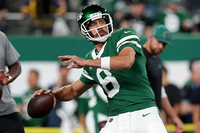 New York Jets quarterback Aaron Rodgers (8) warms up before a game against the New England Patriots at MetLife Stadium. Mandatory Credit: Brad Penner-Imagn Images