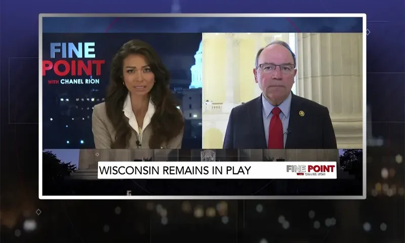 Video still from Fine Point on One America News Network showing a split screen of the host on the left side, and on the right side is the guest, Tom Tiffany.