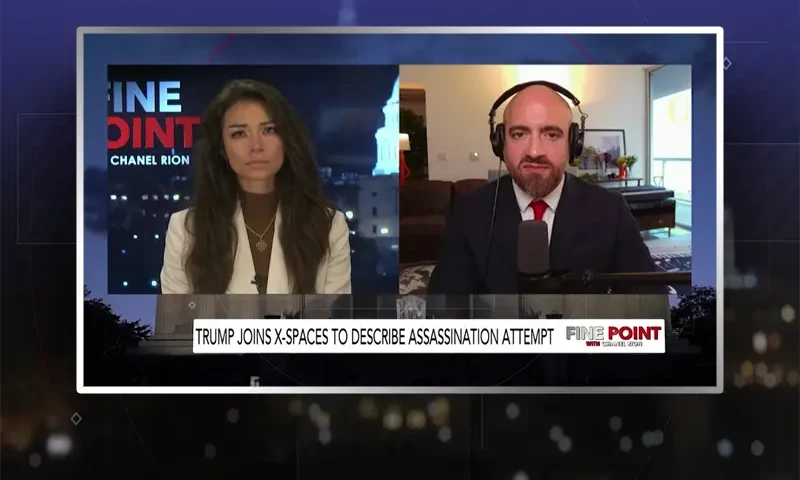 Video still from Fine Point on One America News Network showing a split screen of the host on the left side, and on the right side is the guest, Mike Benz.