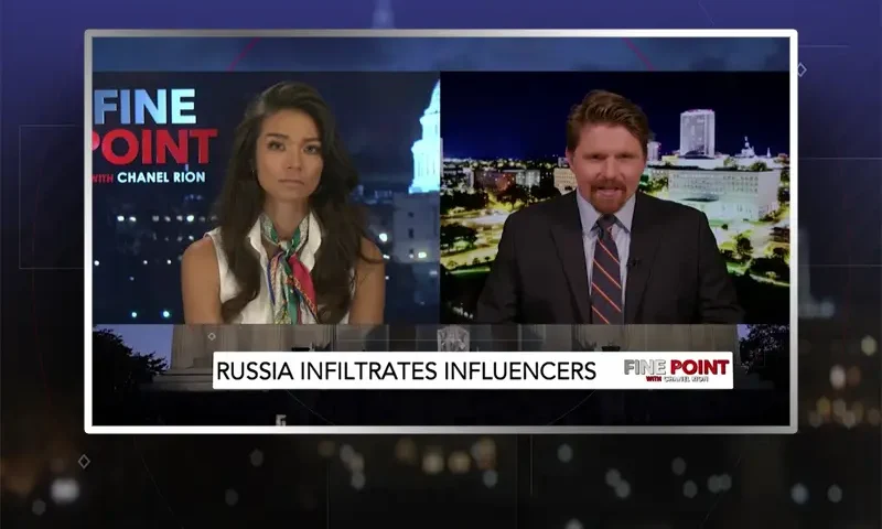 Video still from Fine Point on One America News Network showing a split screen of the host on the left side, and on the right side is the guest, Seamus Bruner.