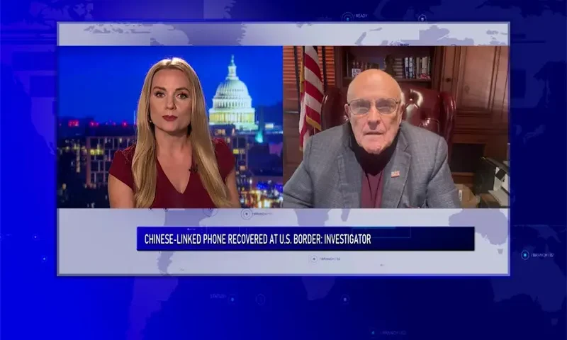 Video still from Ivory Hecker Tonight on One America News Network showing a split screen of the host on the left side, and on the right side is the guest, Rudy Giuliani.