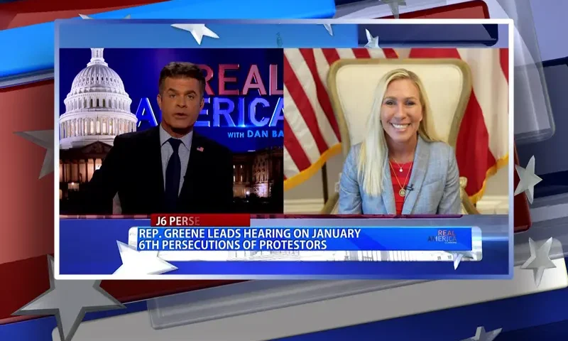 Video still from Real America on One America News Network showing a split screen of the host on the left side, and on the right side is the guest, Rep. Marjorie Taylor Greene.