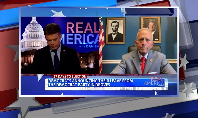 Video still from Real America on One America News Network showing a split screen of the host on the left side, and on the right side is the guest, Rep. Jeff Van Drew.