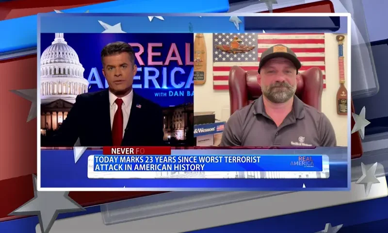 Video still from Real America on One America News Network showing a split screen of the host on the left side, and on the right side is the guest, Chad Robichaux.