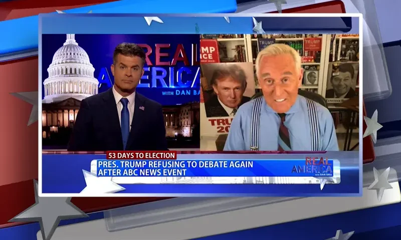 Video still from Real America on One America News Network showing a split screen of the host on the left side, and on the right side is the guest, Roger Stone.