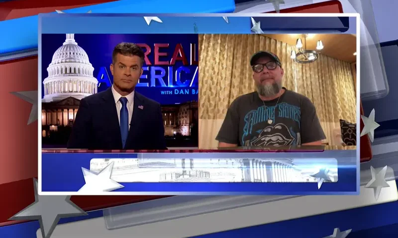 Video still from Real America on One America News Network showing a split screen of the host on the left side, and on the right side is the guest, Josh Macciello.