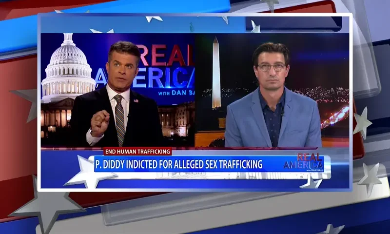 Video still from Real America on One America News Network showing a split screen of the host on the left side, and on the right side is the guest, Jaco Booyens.