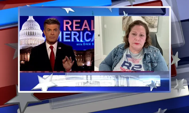 Video still from Real America on One America News Network showing a split screen of the host on the left side, and on the right side is the guest, Paula Knauss-Selph.
