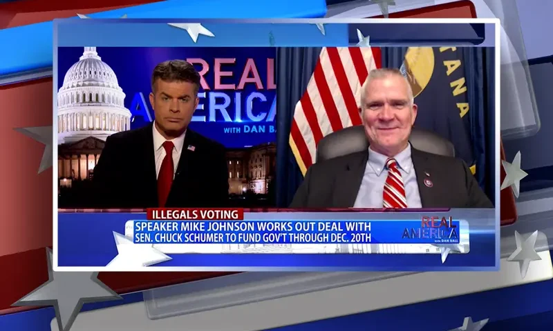 Video still from Real America on One America News Network showing a split screen of the host on the left side, and on the right side is the guest, Rep. Matt Rosendale.