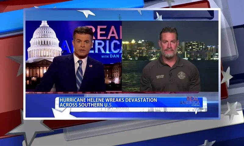 Video still from Real America on One America News Network showing a split screen of the host on the left side, and on the right side is the guest, Rep. Greg Steube.