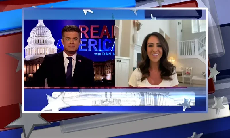Video still from Real America on One America News Network showing a split screen of the host on the left side, and on the right side is the guest, Rep. Lauren Boebert.