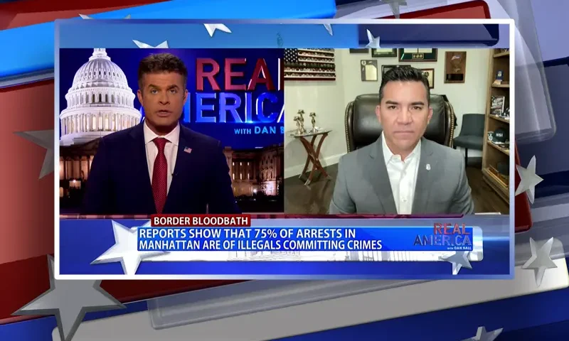 Video still from Real America on One America News Network showing a split screen of the host on the left side, and on the right side is the guest, Victor Avila.
