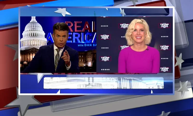 Video still from Real America on One America News Network showing a split screen of the host on the left side, and on the right side is the guest, Caroline Sunshine.