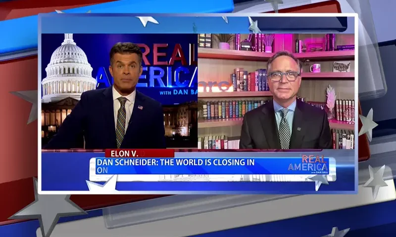 Video still from Real America on One America News Network showing a split screen of the host on the left side, and on the right side is the guest, Dan Schneider.