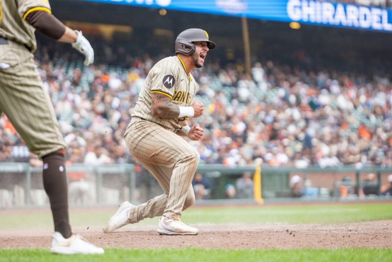 San Diego Padres outfielder David Peralta (21) scores during the tenth inning against the San Francisco Giants at Oracle Park. Mandatory Credit: Bob Kupbens-Imagn Images