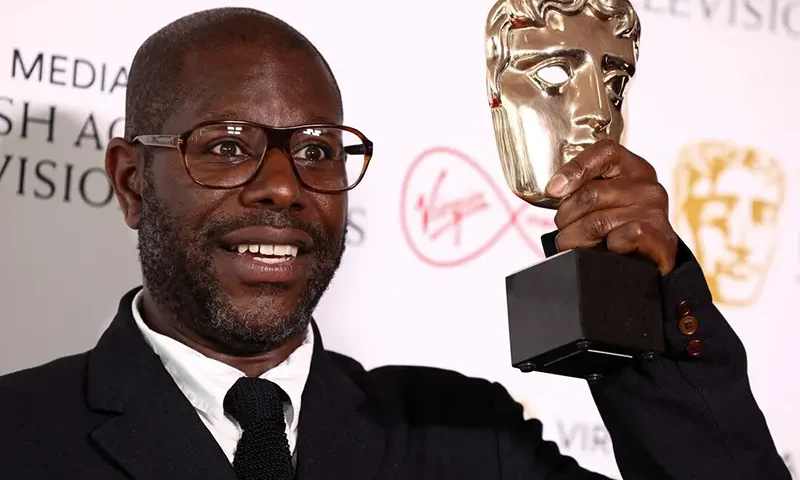 Director Steve McQueen poses with the "Best Factual Series" award for "Uprising" at the British Academy Television Awards in London, Britain, May 8, 2022. REUTERS/Henry Nicholls/File Photo