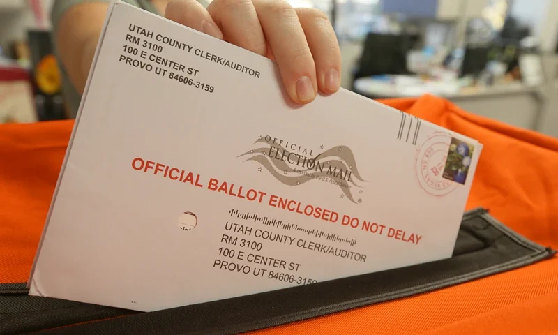 PROVO, UT - November 6: A employee at the Utah County Election office puts mail in ballots into a container to register the vote in the midterm elections on November 6, 2018 in Provo, Utah. (Photo by George Frey/Getty Images)