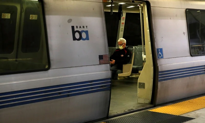 SAN FRANCISCO, CALIFORNIA - APRIL 08: A Bay Area Rapid Transit (BART) passenger rides in an empty train car on April 08, 2020 in San Francisco, California. BART announced that it is slashing daily service as ridership falls dramatically due to the coronavirus shelter in place order. Starting Wednesday, regular Monday through Friday service will be reduced to running trains every half hour between 5 am and 9 pm. (Photo by Justin Sullivan/Getty Images)