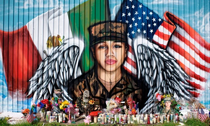 Candles and flowers decorate a makeshift memorial for US Army Specialist Vanessa Guillen at Power House Gym on August 14, 2020, in Houston, Texas. - Guillen's murder the subsequent suicide of the chief suspect, US Army specialist Aaron Robinson, has put a spotlight on sexual harassment in the US military. Guillen, a 20-year-old US Army specialist at Fort Hood in Texas, went missing more than two months ago. After a weeks-long search, a lawyer for the Guillen family confirmed that human remains found on June 30 near her former base were those of the missing soldier. (Photo by Mark Felix / AFP) (Photo by MARK FELIX/AFP /AFP via Getty Images)
