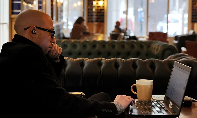 A man sits with his laptop at a cafe in Beirut on January 14, 2022. - The music is often hushed and the atmosphere studious -- for the patrons filling Beirut's cafes these days, the most important things are good lighting and stable wi-fi. That's because they now serve as substitute workplaces for people grappling with drastic electricity shortages and internet cuts stemming from Lebanon's unrelenting economic crisis. (Photo by JOSEPH EID / AFP) (Photo by JOSEPH EID/AFP via Getty Images)