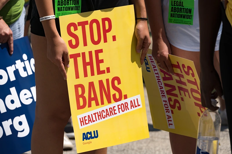 A protester holds a sign while marching and chanting through Downtown Atlanta, in opposition to Georgia's new abortion law on July 23, 2022 in Atlanta, Georgia. A federal appeals court has decided to allow a Georgia law that bans abortion after six weeks of pregnancy to go into effect. Previously Georgia law allowed abortions up to 20 weeks of pregnancy. (Photo by Megan Varner/Getty Images)